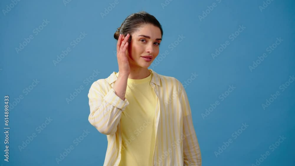 Young lady examines own appearance smiling cheerfully Young lady examines own appearance smiling cheerfully