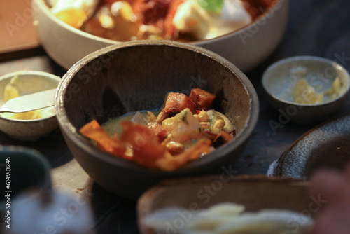 Refrescante ceviche de peixe branco e atum, delicadamente marinados em suco cítrico, servido em um lindo bowl de cerâmica artesanal. A combinação de sabores e a apresentação encantadora.