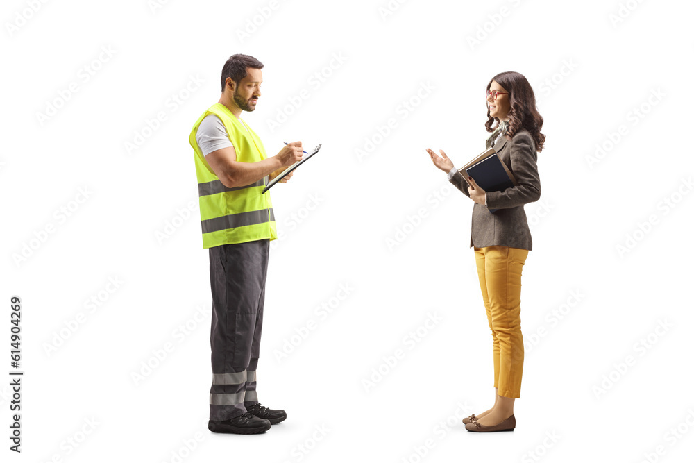 Full length profile shot of a road assistance agent writing a document and listening to a young woman Full length profile shot of a road assistance agent writing a document and listening to a young woman