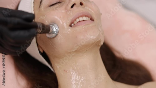 RF skincare, Beautician techniques, Cosmetology practices. Skin care expert administers RF lifting session, which is also referred to as radio frequency lifting, to client. photo