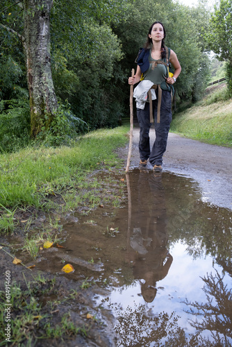 Young woman pilgrim walking on a trail of the way of saint james. Camino de Santiago photo