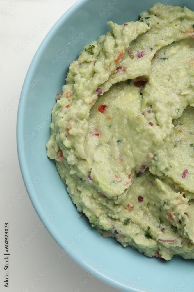 Bowl with delicious fresh guacamole on white table, top view Bowl with delicious fresh guacamole on white table, top view