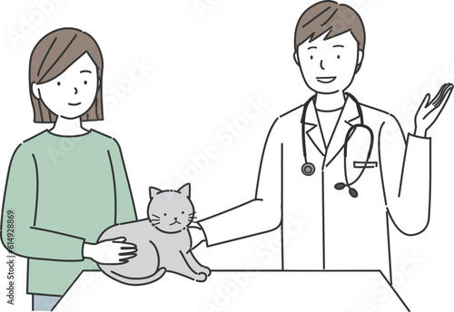 猫の診察をする獣医師と飼い主