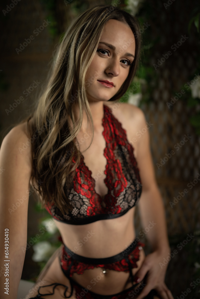 blonde female posing on a tub with floral background blonde female posing on a tub with floral background