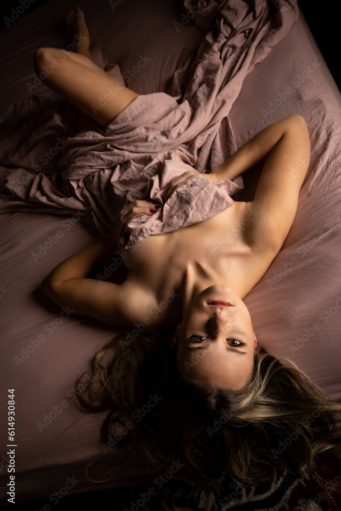 blonde female nude in pink sheet bed blonde female nude in pink sheet bed