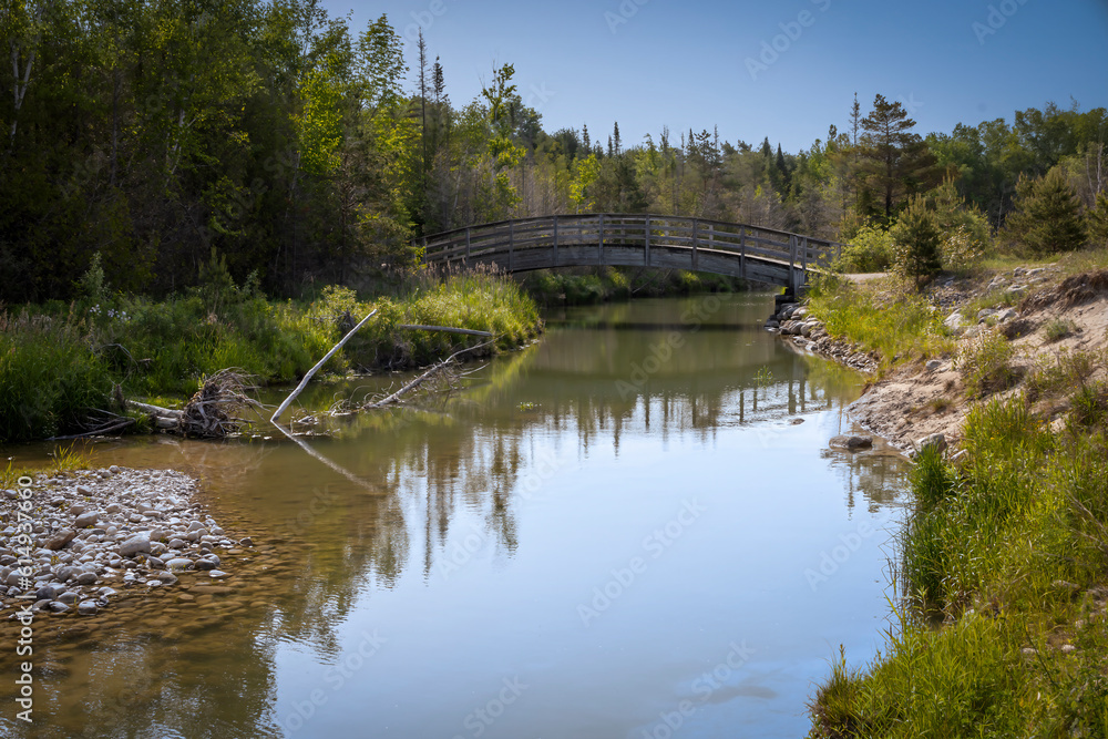 The rainbow bridge crosses the river on the River Trail in Inverhuron Provincial Park, Ontario.