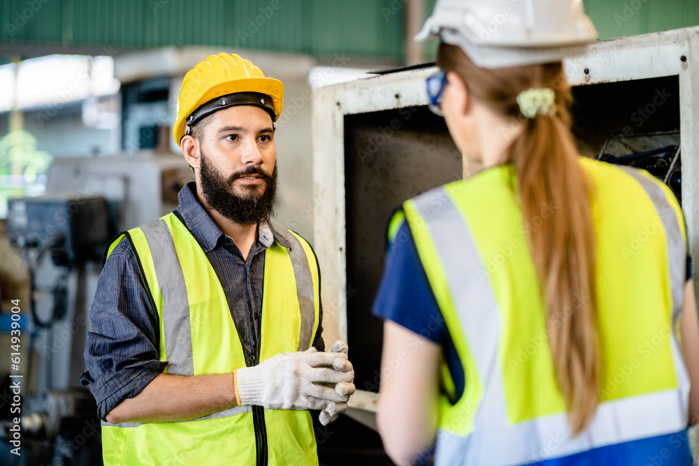 Male and Female Mechanical Engineers using a laptop and Discussing