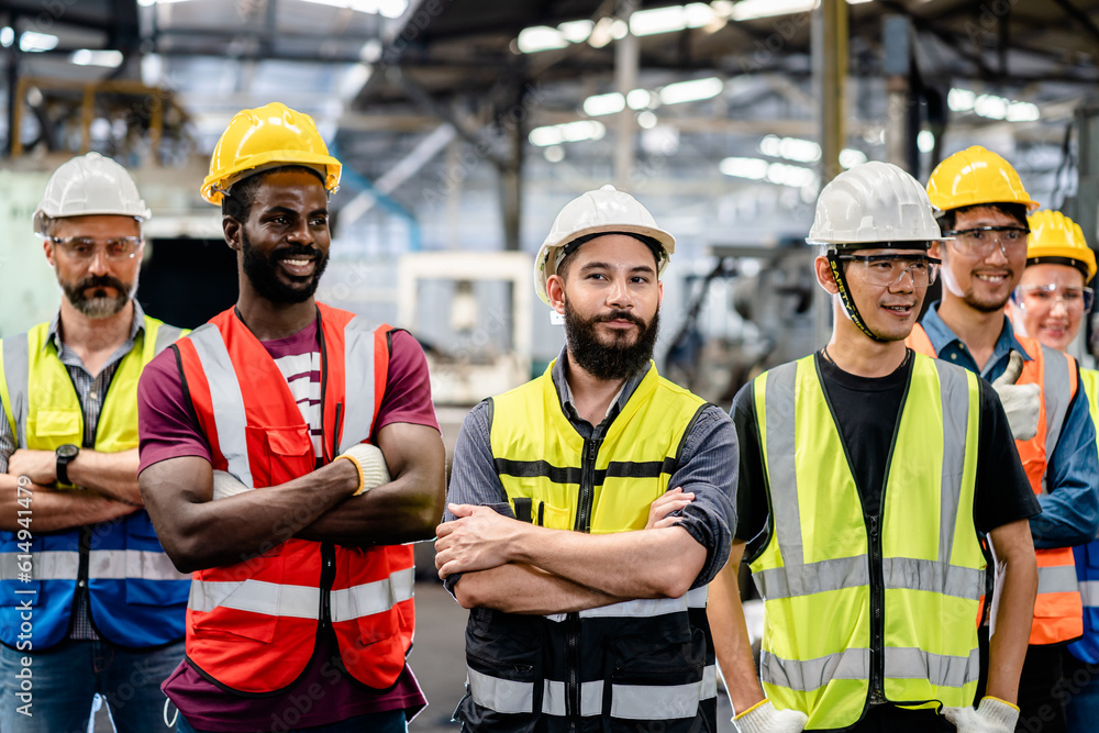Portrait of Groups diversity workers factory or engineering standing cross arms look confident in an industrial manufacturing factory, Working together, Coordination and Teamwork concept Portrait of Groups diversity workers factory or engineering standing cross arms look confident in an industrial manufacturing factory, Working together, Coordination and Teamwork concept