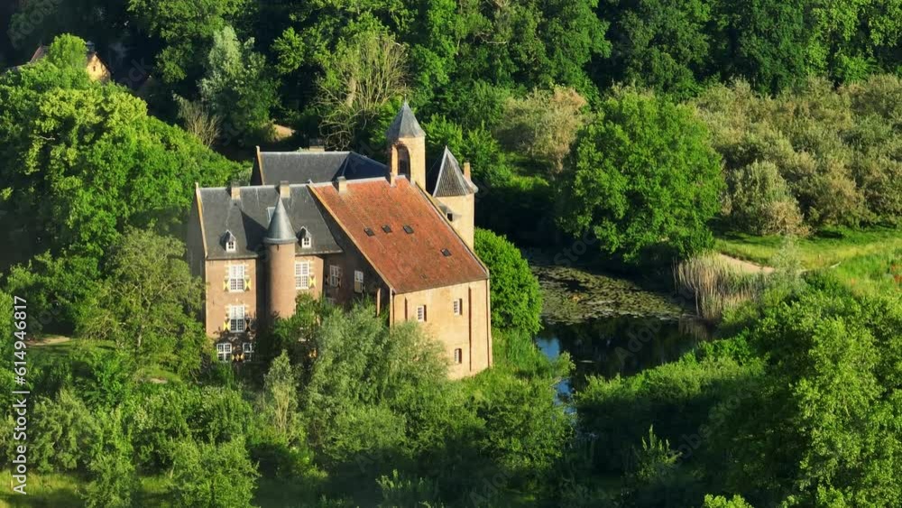 Historic medieval Waardenburg castle with lush surrounding woodland. Drone arc Historic medieval Waardenburg castle with lush surrounding woodland. Drone arc