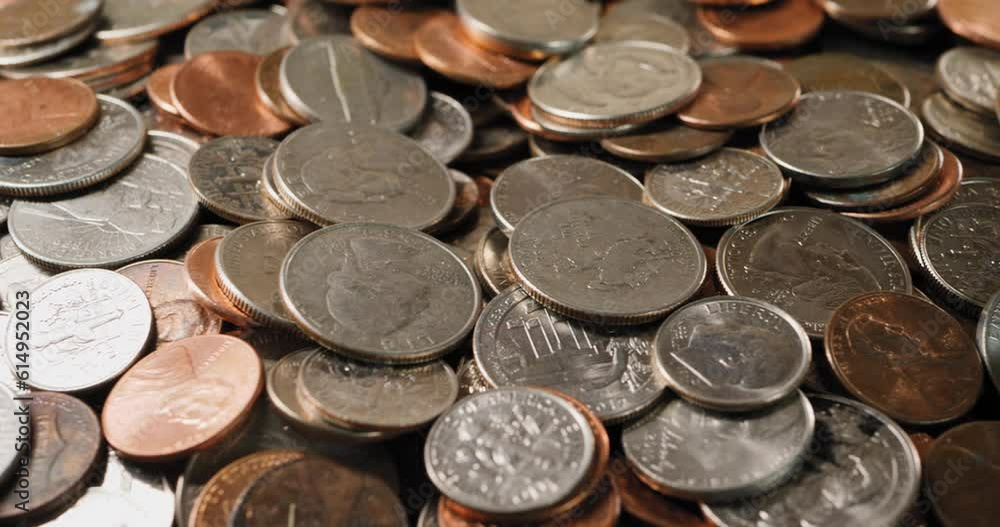 A pile of pennies, quarters, dimes, nickels, coins, currency, money. Slider shot left to right A pile of pennies, quarters, dimes, nickels, coins, currency, money. Slider shot left to right