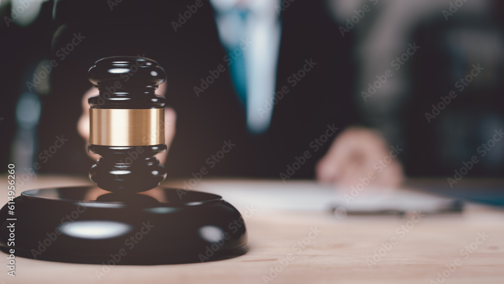 Wooden judge gavel on table ,justice in punishment of offenses and criminal verdicts ,concept of law and justice ,Lawyer or judge examining documents ,legal contract consulting ,court proceedings Wooden judge gavel on table ,justice in punishment of offenses and criminal verdicts ,concept of law and justice ,Lawyer or judge examining documents ,legal contract consulting ,court proceedings