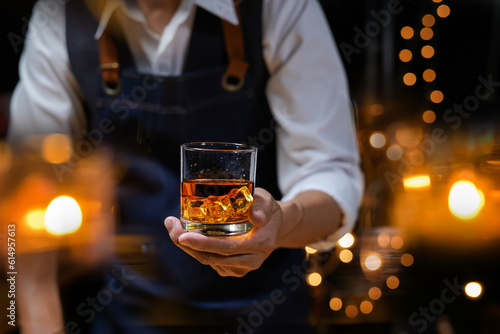 Bartender Serve Whiskey  on wood bar  