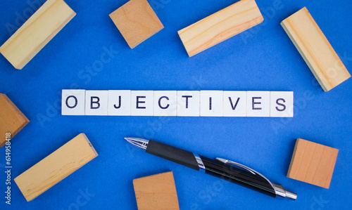 pen and alphabet letters with objective words. objective concept or goal direction of something