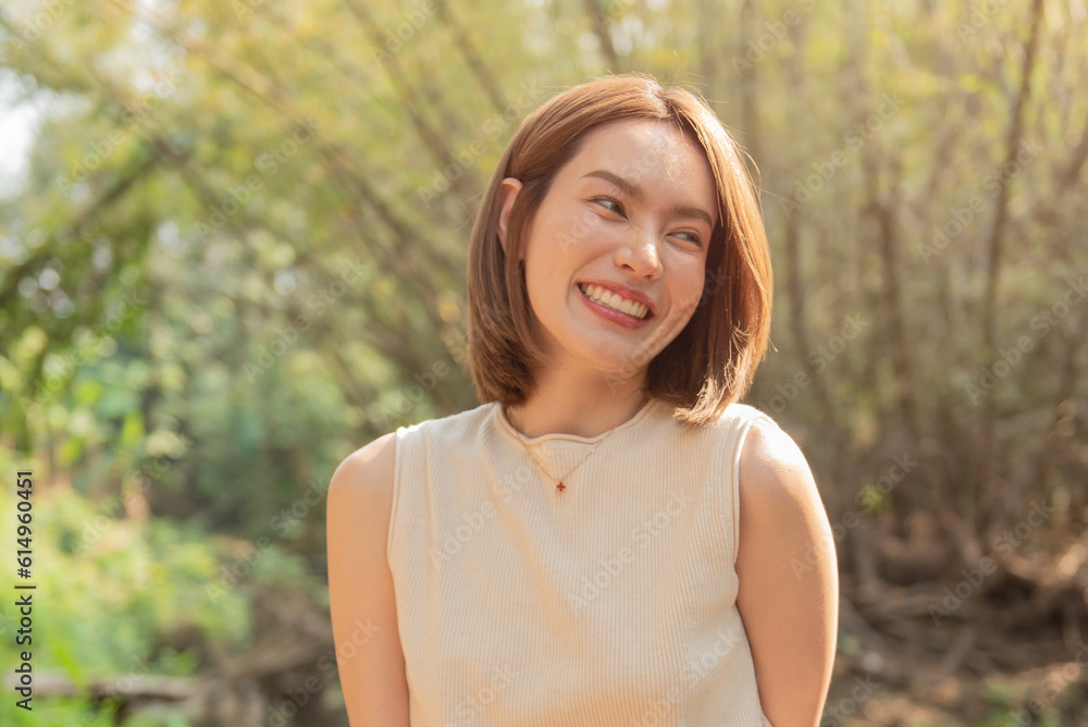 Woman smiling with perfect smile and white teeth in a park and looking at camera, Portrait of beautiful woman smiling and looking away at park during sunset. Happy cheerful girl laughing closeup. Woman smiling with perfect smile and white teeth in a park and looking at camera, Portrait of beautiful woman smiling and looking away at park during sunset. Happy cheerful girl laughing closeup.
