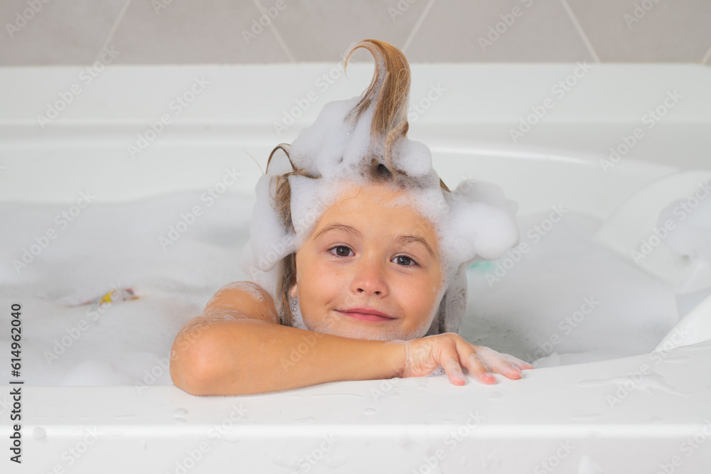 Foto de Kids shampoo. Little child in a bath tub. Washing in bath. Kid
