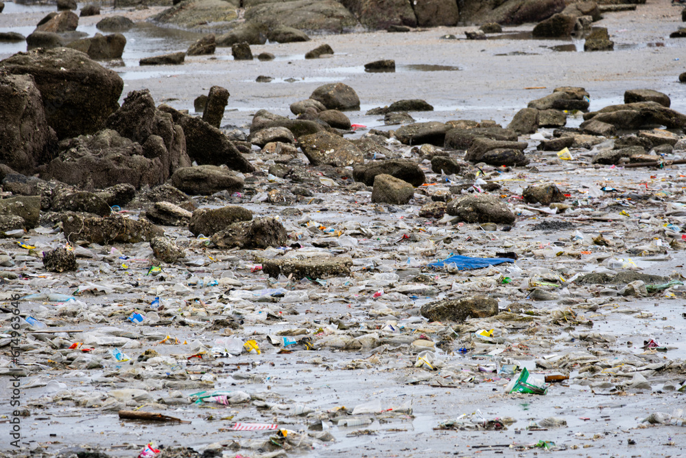 Obraz premium Beach debris, plastic cups and plastic bags. Marine debris is one of the world's major environmental problems.