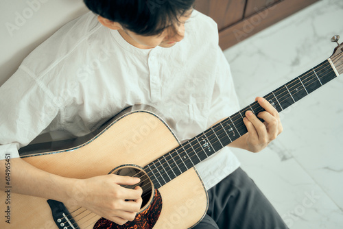 young male musician playing acoustic guitar , Close up classic guitar , finger style . happy mood white background with copy space can use for music school.