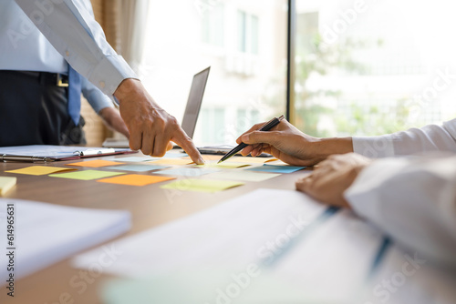 business people pointing on data paper on office table..