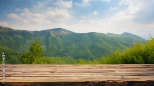 Empty old Wooden table in front of green mountain and blue sky
