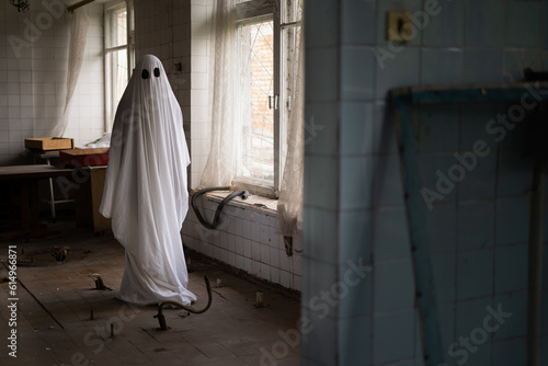 Ghost in white sheet walk in abandoned ruined clinic