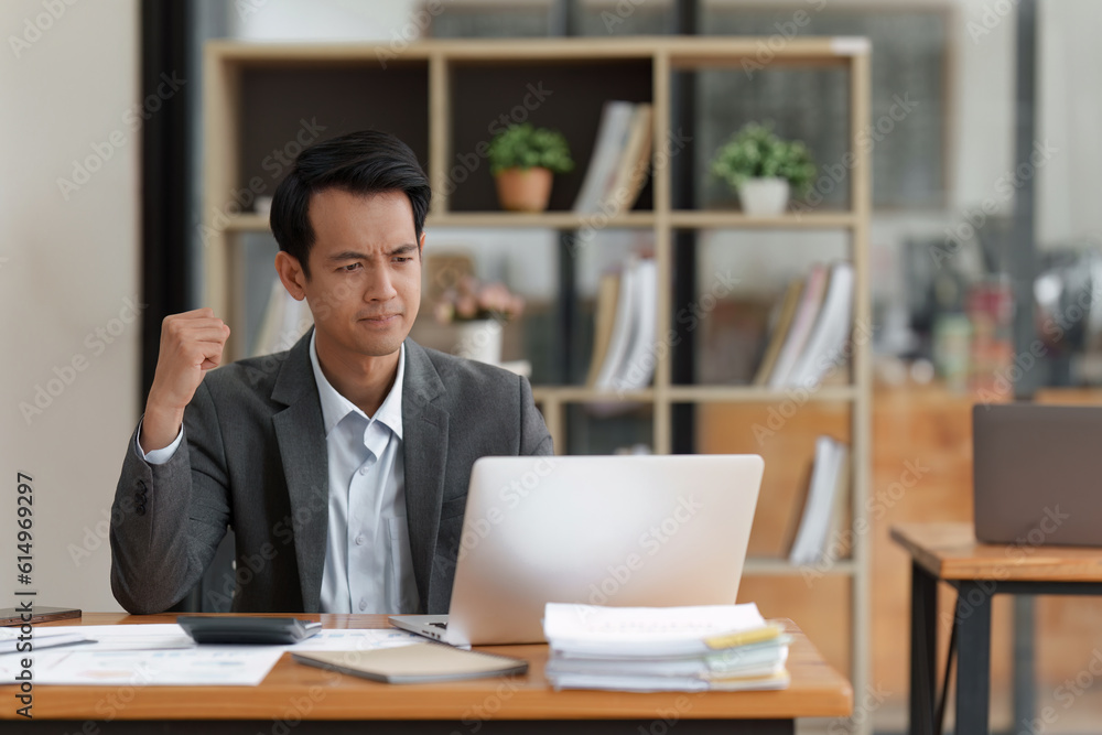 Financier a asian man feel stress with works, uses a laptop, makes a report to a finance company. Accounting and financial concept Financier a asian man feel stress with works, uses a laptop, makes a report to a finance company. Accounting and financial concept