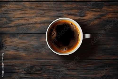 Cup of coffee on wooden background. Top view with copy space
