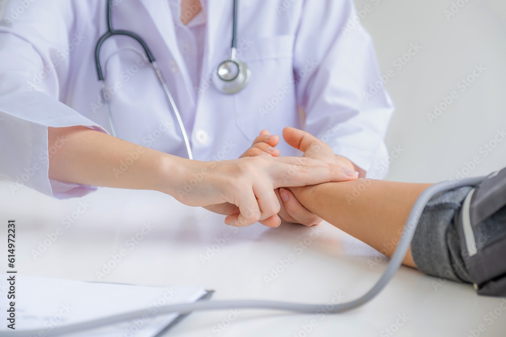 The doctor hand examines the patient's pulse and records the results, health medical checkup concept The doctor hand examines the patient's pulse and records the results, health medical checkup concept