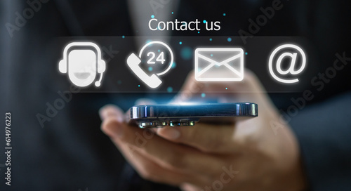 Human business ues smartphone with call center on screen contact us, email, address, operator, customer, support, phone services agen, chat message, customer support hotline.contact us concept