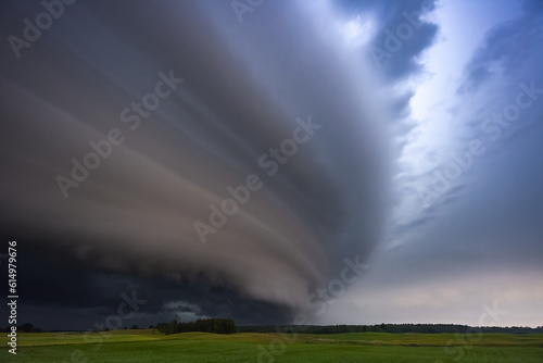 Angry supercell storm influenced by Climate change. Dangerous storm supercell shelf cloud with layers.