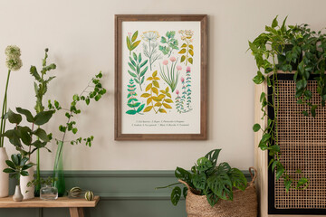 Spring composition of living room interior with mock up poster frame, rattan sideboard, wooden bench, vase with leaves and personal accessories. Home decor. Template.