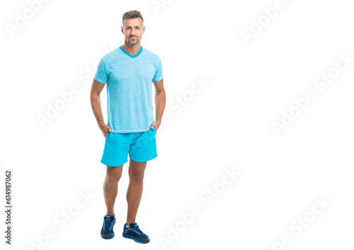 Sport man standing wearing gym sportswear, copy space banner. Handsome sport man after workout in studio. runner sport man isolated on white background. Athletic mature sport man standing