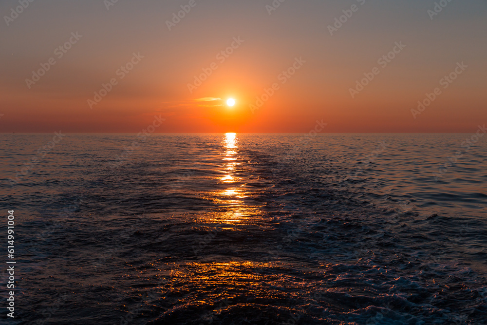 Sea sunset with ship trace