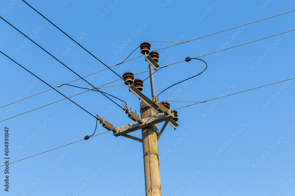 Old wooden power transmission pole with wires Old wooden power transmission pole with wires
