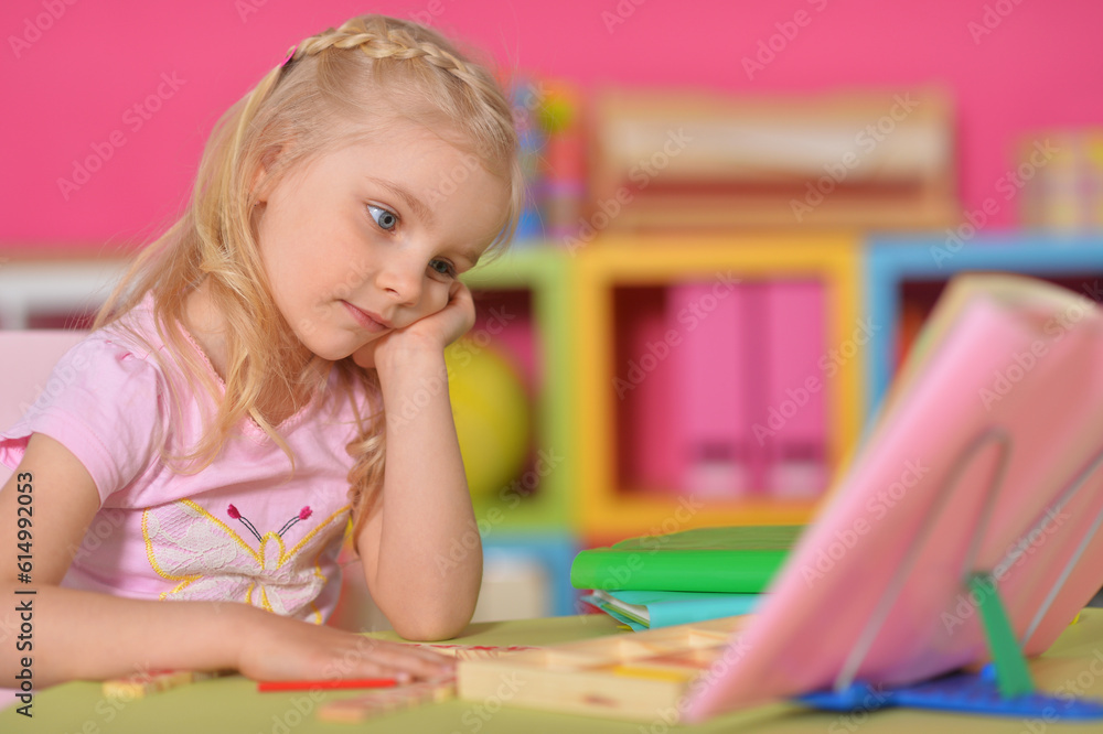 Little cute girl studying at the table at home Little cute girl studying at the table at home