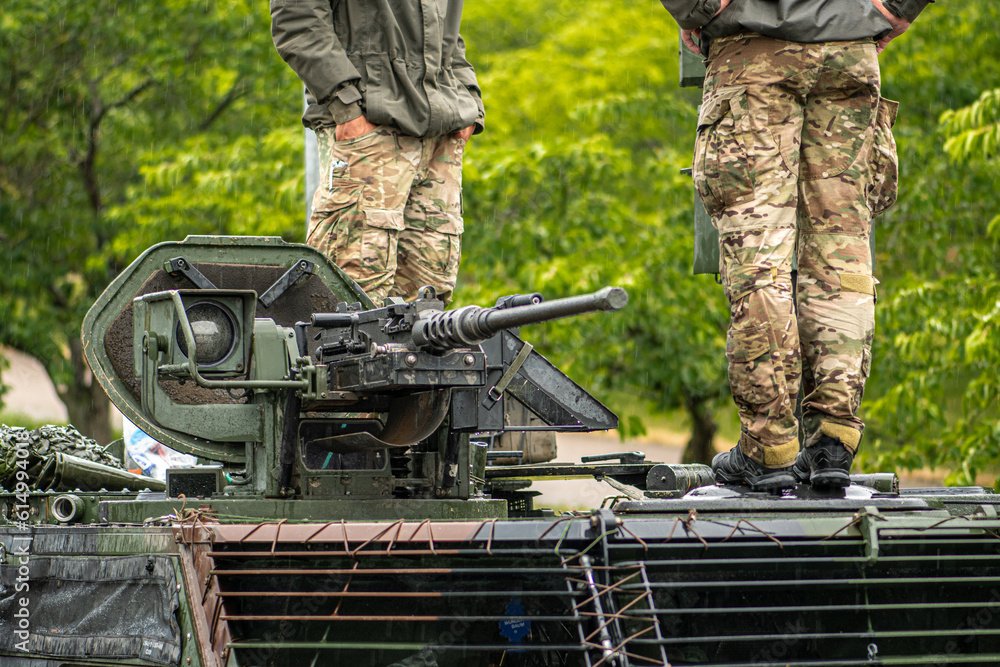 Soldiers on a Stryker combat military vehicle with a machine gun and an ...