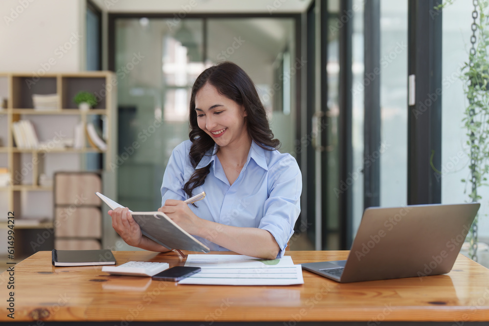 Financier a asian woman works, uses a laptop, makes a report to a finance company. Accounting and financial concept Financier a asian woman works, uses a laptop, makes a report to a finance company. Accounting and financial concept