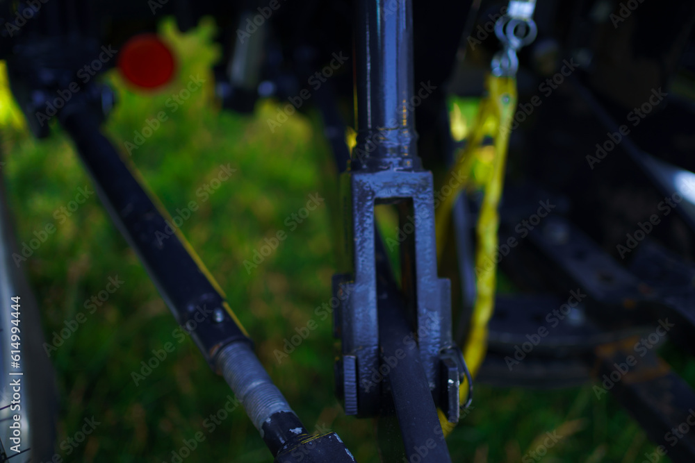 Red tractor with tooth harrow in the green field in Ukraine Red tractor with tooth harrow in the green field in Ukraine