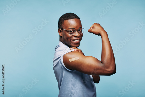 African man flexing after a vaccination photo