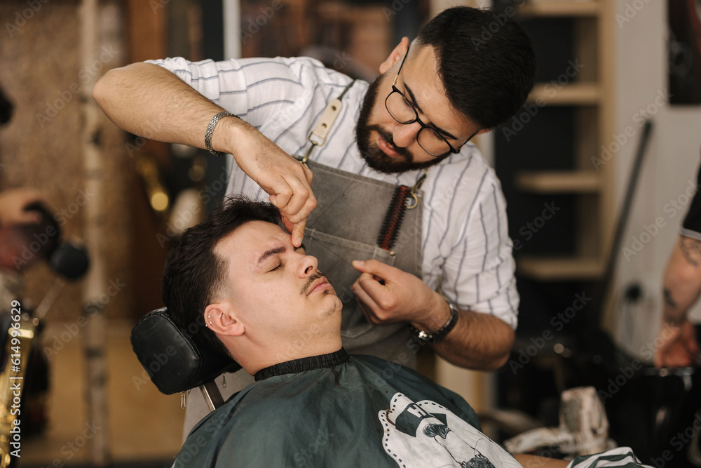 Threading Machine Barber Process of threading procedure in barber shop. Professional barber ...