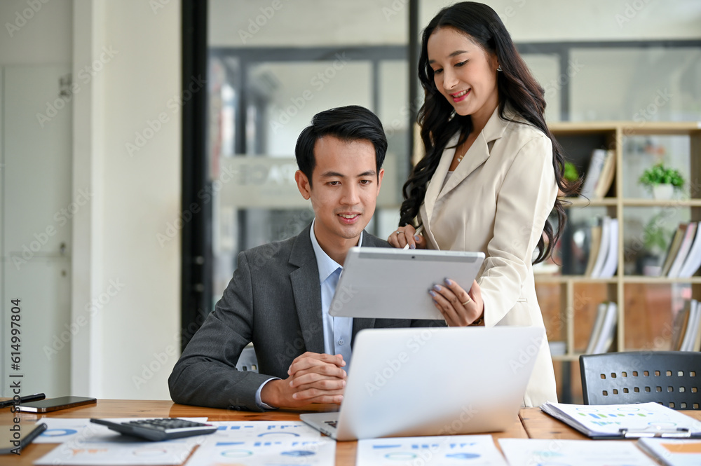 A beautiful Asian businesswoman is discussing work, analyzing business financial data A beautiful Asian businesswoman is discussing work, analyzing business financial data