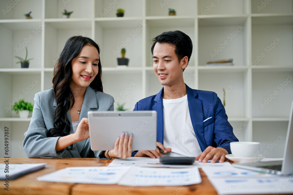 A businesswoman and a businessman are working on a new project in the office together. A businesswoman and a businessman are working on a new project in the office together.