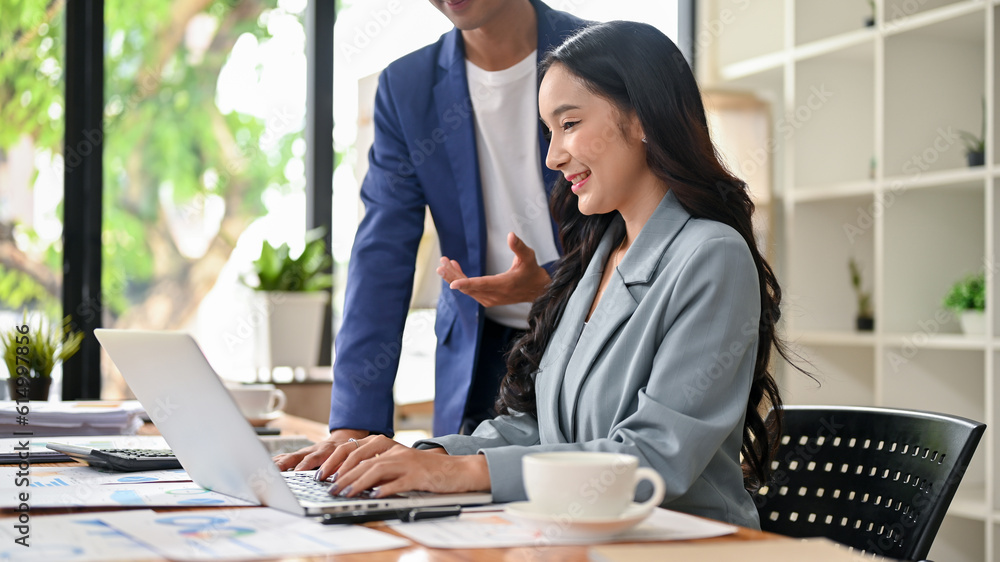 A rear view of a beautiful Asian businesswoman is being complimented by her male boss A rear view of a beautiful Asian businesswoman is being complimented by her male boss