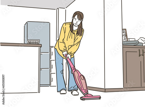 掃除機をかけるアジア人の若い女性
