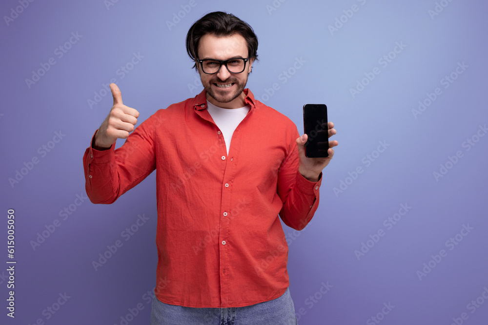 smart confident young brunette man in glasses advertises smartphone smart confident young brunette man in glasses advertises smartphone