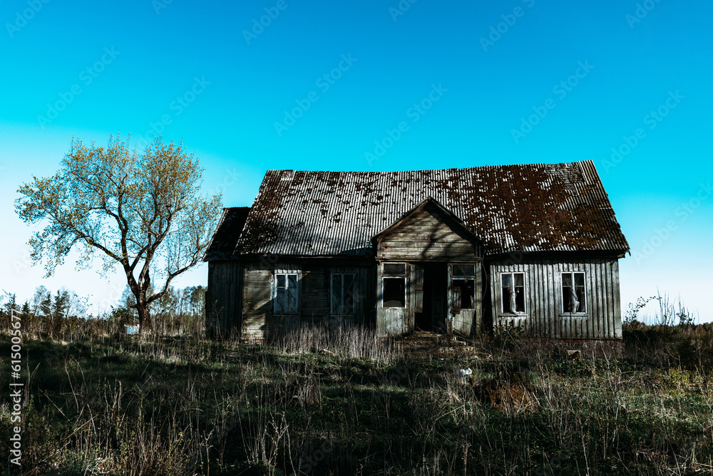 Abandoned 19th century house in a rural field at summer.Creepy summer dark evening.Toned. Abandoned 19th century house in a rural field at summer.Creepy summer dark evening.Toned.