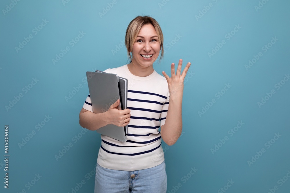 horizontal photo of attractive business woman in casual striped sweater with laptop showing four fingers on blue background horizontal photo of attractive business woman in casual striped sweater with laptop showing four fingers on blue background