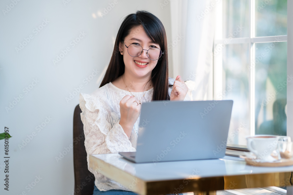 Happy successful business of asian freelance people business female expressed confidence embolden working with laptop computer with coffee cup and smartphone in coffee shop ,communication concept Happy successful business of asian freelance people business female expressed confidence embolden working with laptop computer with coffee cup and smartphone in coffee shop ,communication concept