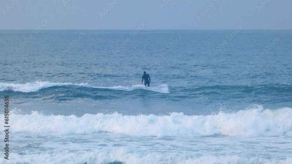 close view of surfer decides to relinquish the opportunity presented by a small wave. close view of surfer decides to relinquish the opportunity presented by a small wave.