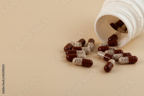 Fotografía Creon pills spilled out of plastic jar, selective focus