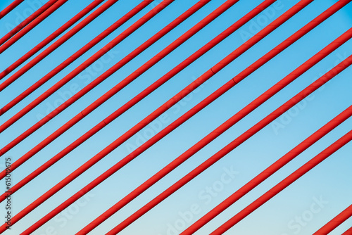 Red cable of a cable car bridge. Red wire background. Symmetry concept, construction.